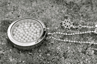 Silver locket full of pearls on a ball chain