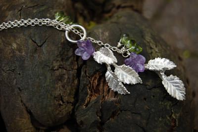 Delicate silver leaves with amethyst flowers and peridot berries