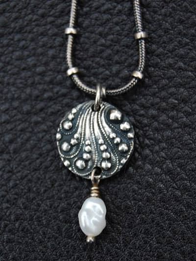 Silver charm with pearl drop